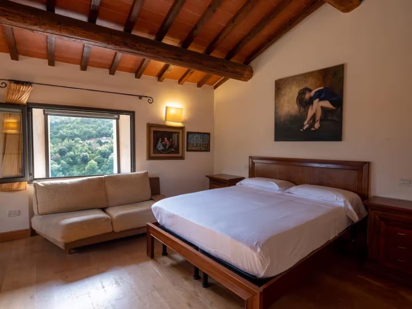 Villa bedroom with timber ceiling and countryside windows