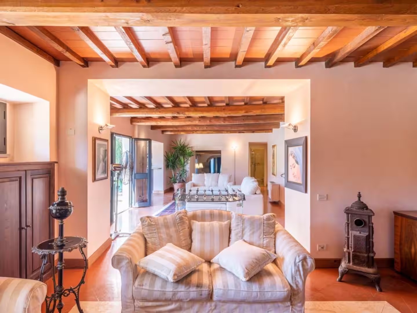 Inviting villa salon with timber beams and comfortable seating